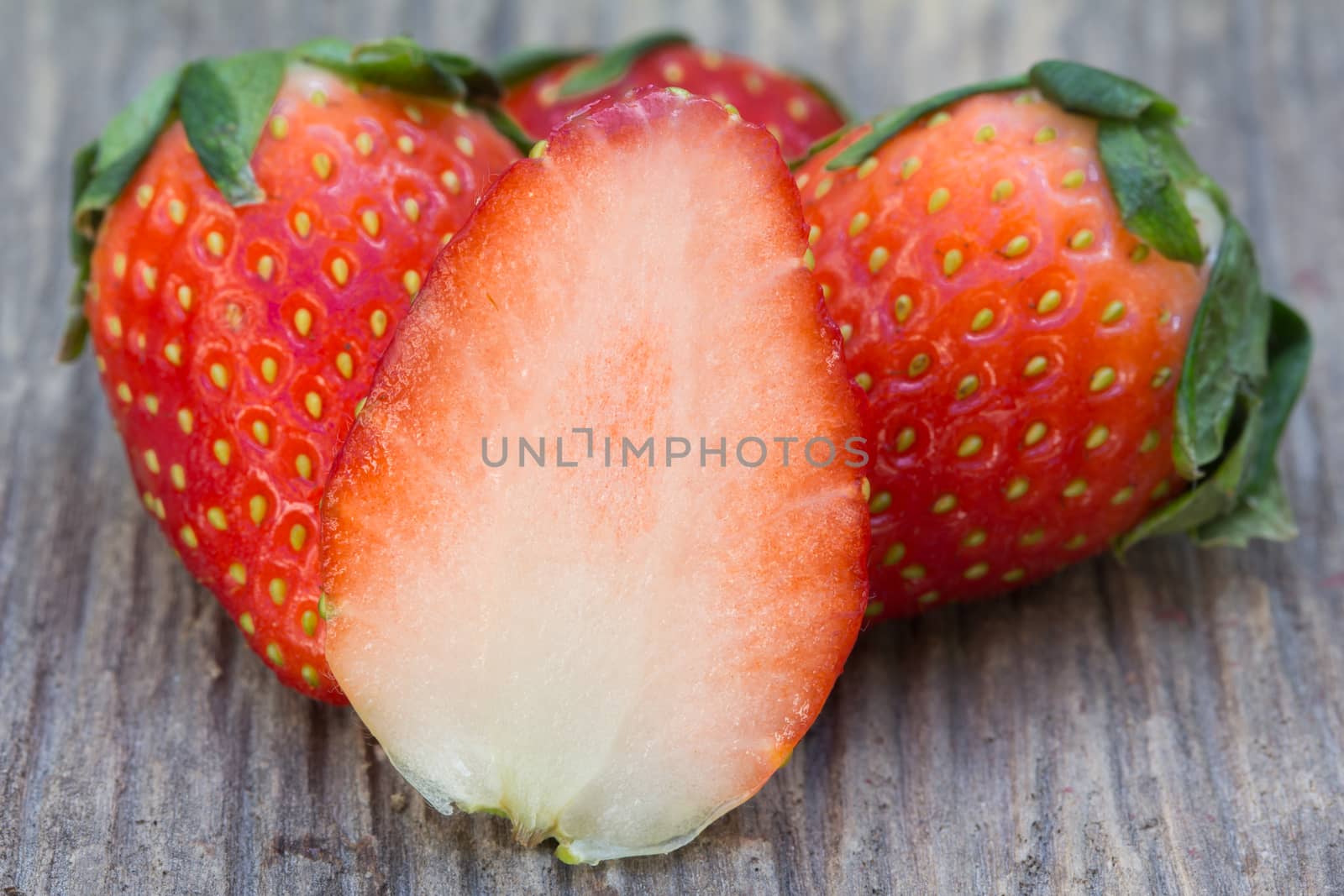 Fresh strawberries on wood background, close up