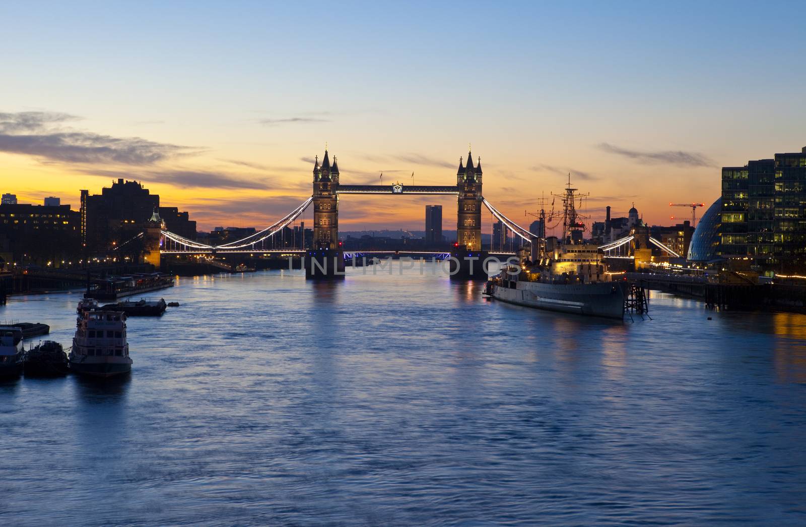 Sunrise in London with Tower Bridge, HMS Belfast, City Hall and the river Thames in the foreground.