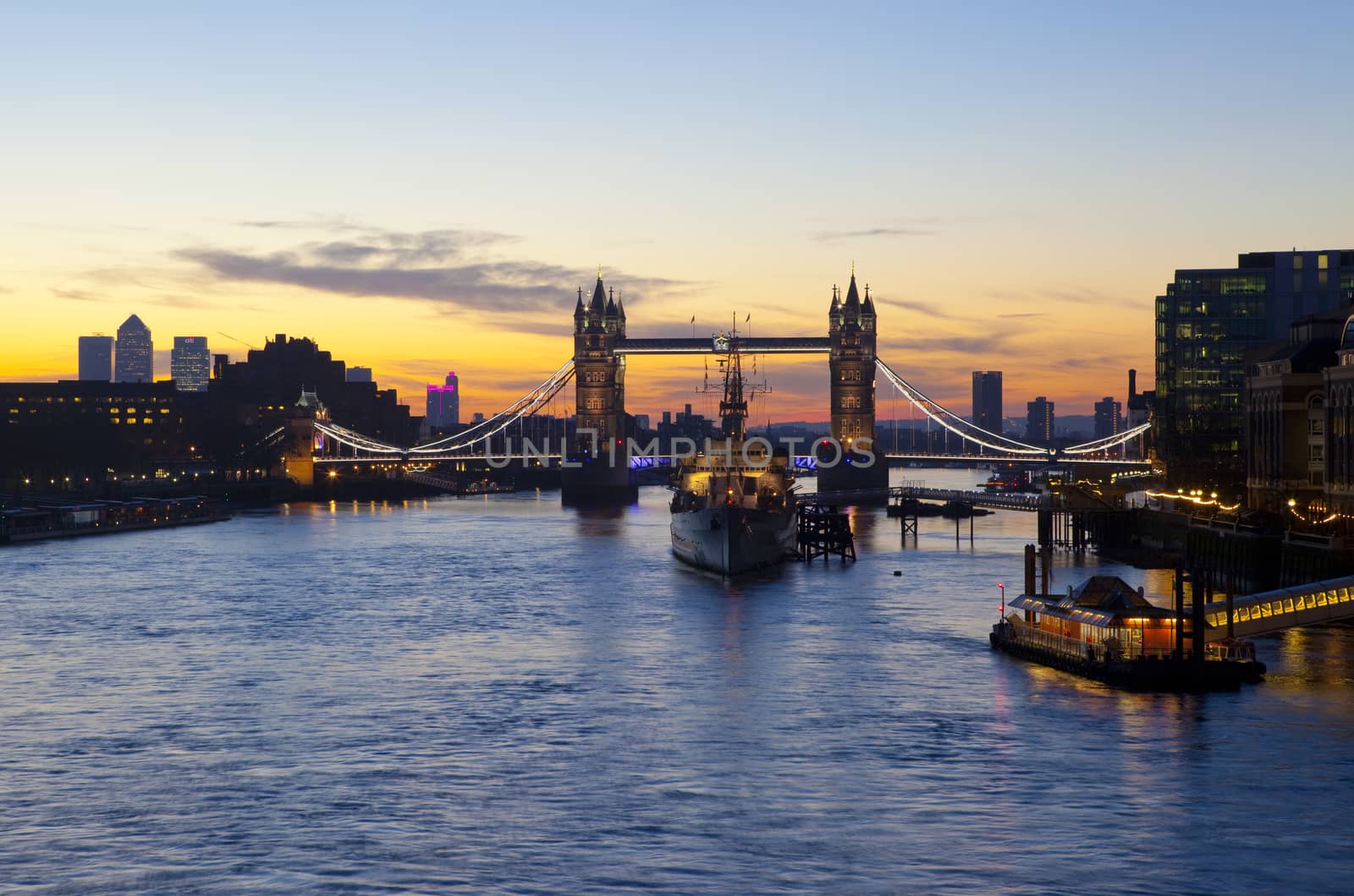 London sunrise with Tower Bridge, HMS Belfast and the River Thames in the foreground.