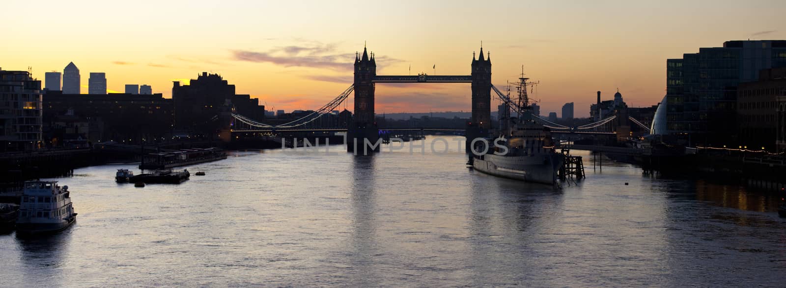 A panoramic view of a London Sunrise taking in the sights of the river Thames, Tower Bridge, HMS Belfast and Docklands.