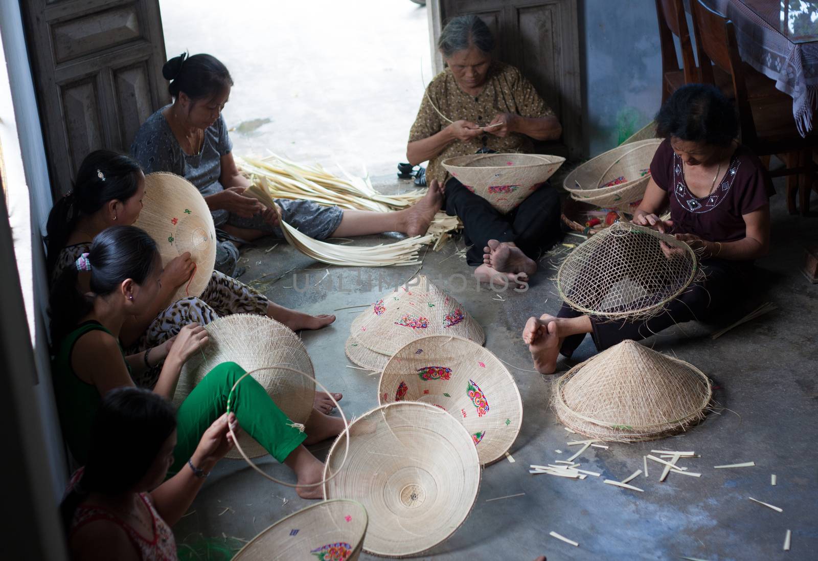 QUY NHON, VIET NAM- JUNE 16: People working indoor, they making conical hat, Quy Nhon, June 16,2012