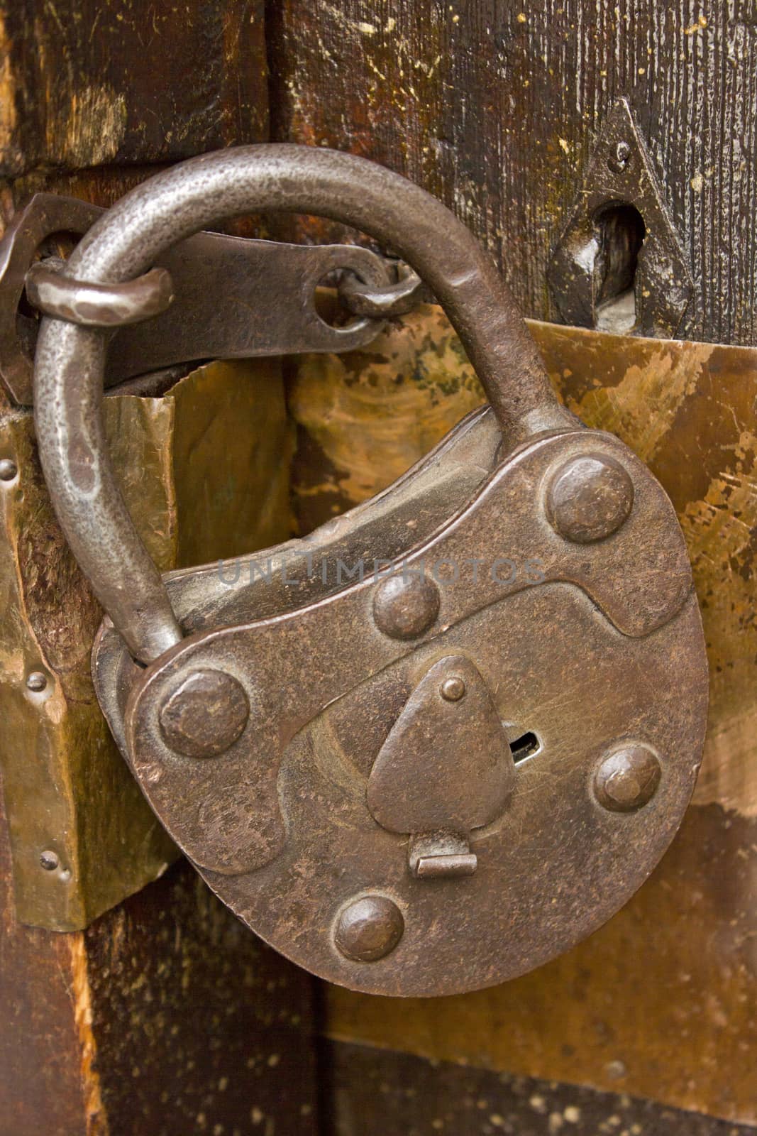 Vintage lock on a old wooden church door.