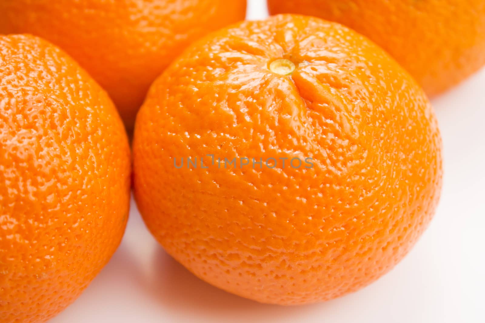 Vibrant mandarin fruit on a white background.