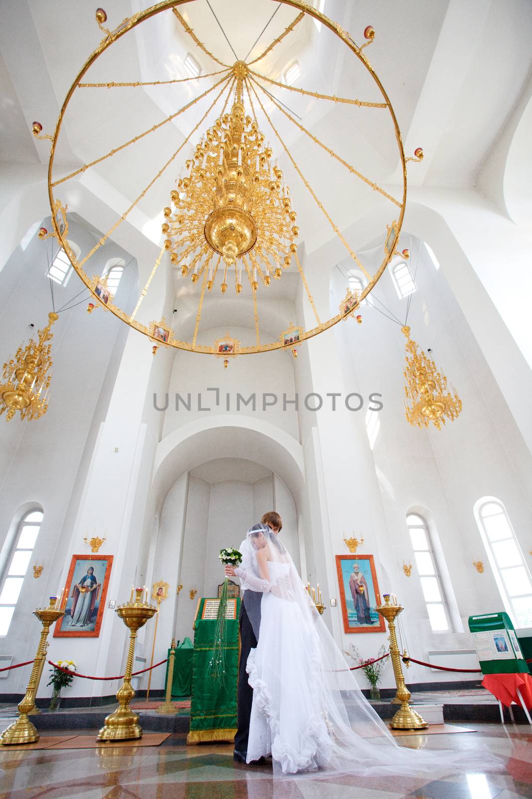 bride and groom in the church by vsurkov
