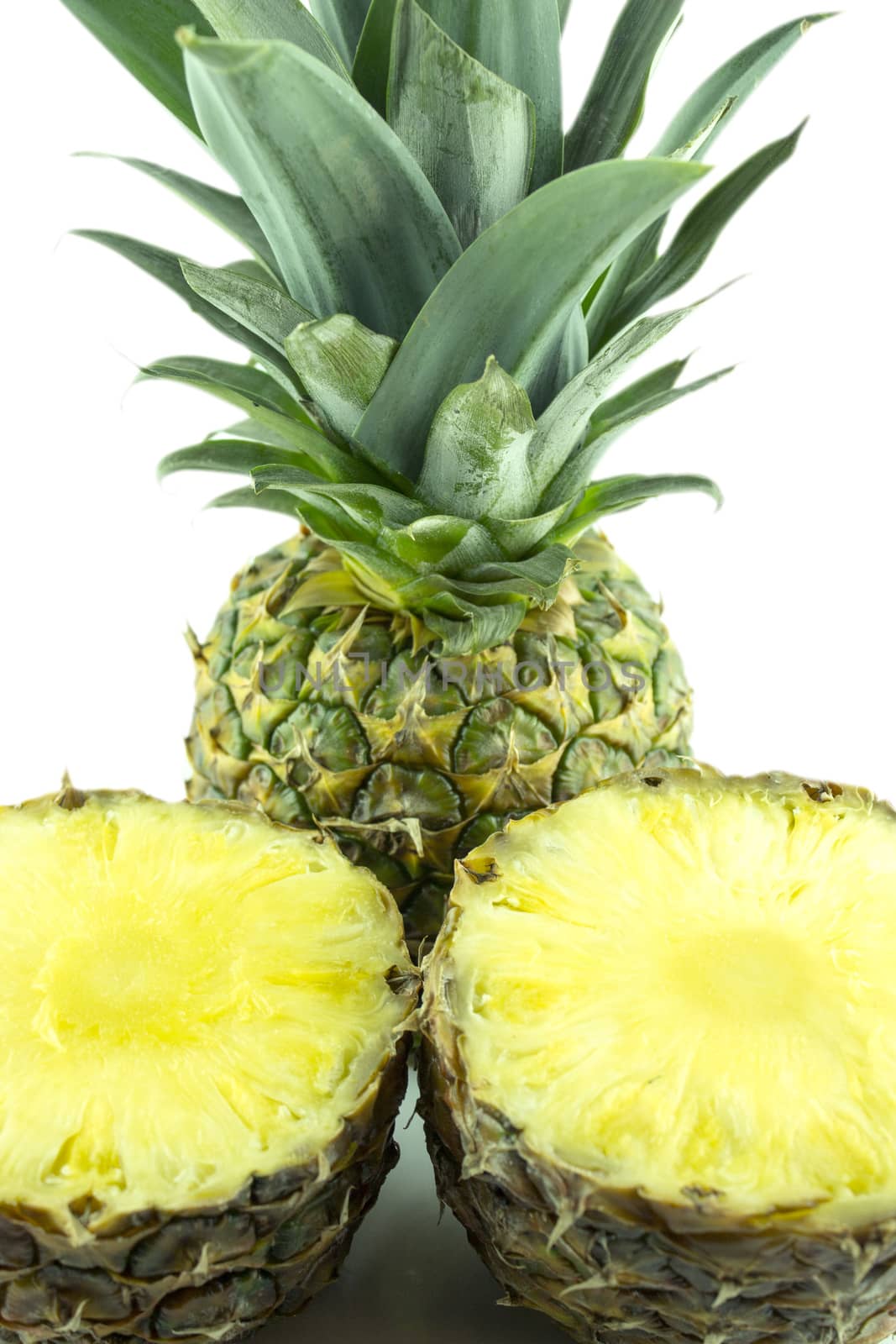 Ripe pineapple with slices isolated on white background