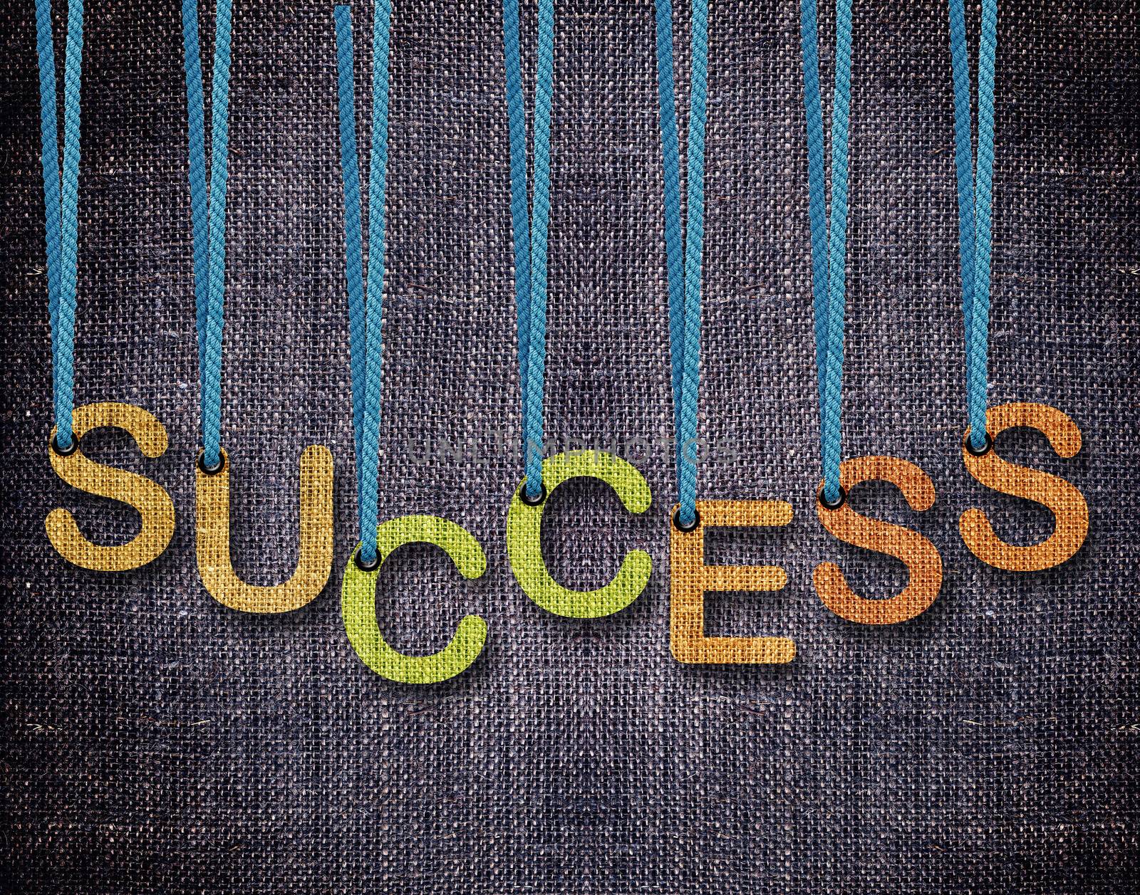 Success Letters hanging strings with blue sackcloth background.