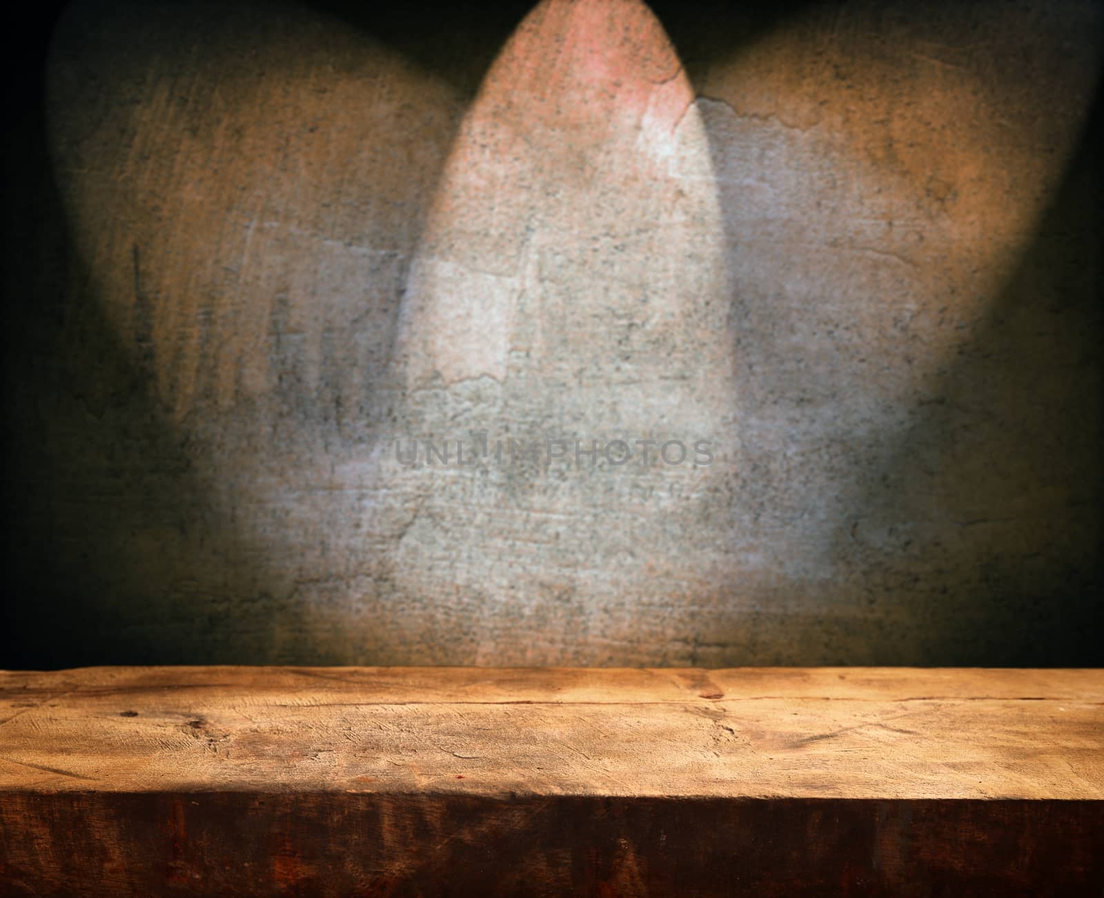 Empty wooden table and dark brown wall in background