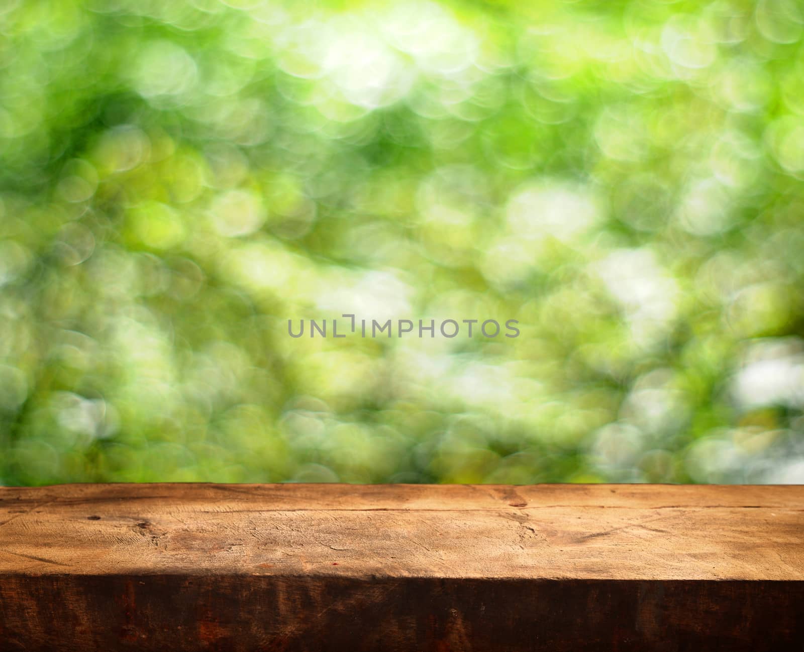 Empty wooden table and green summer background