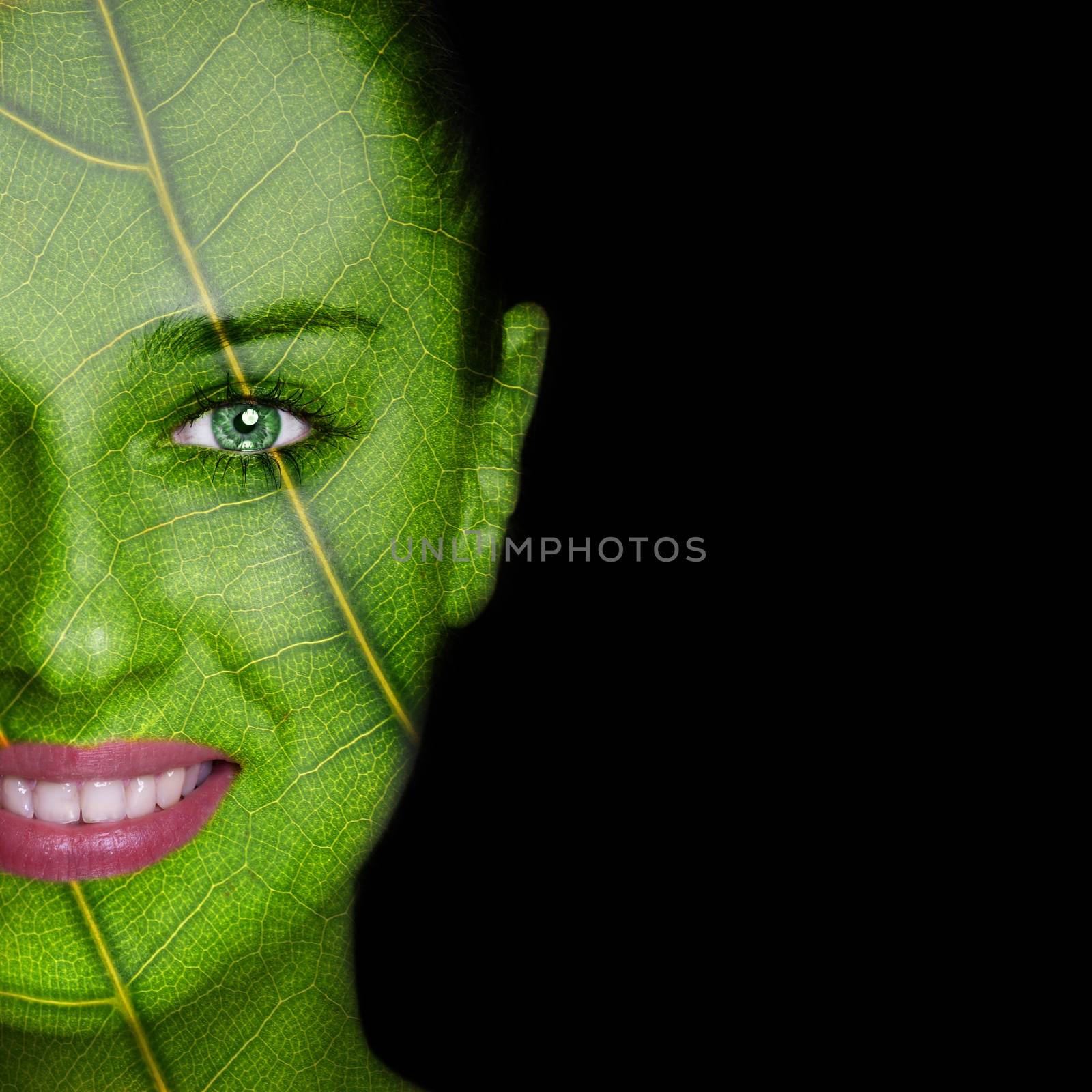 Nature concept - woman face covered with leaf texture