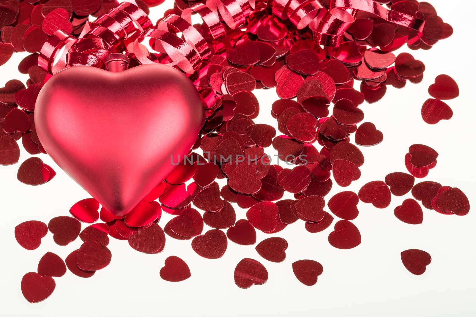 small red confetti and big hearts on white background