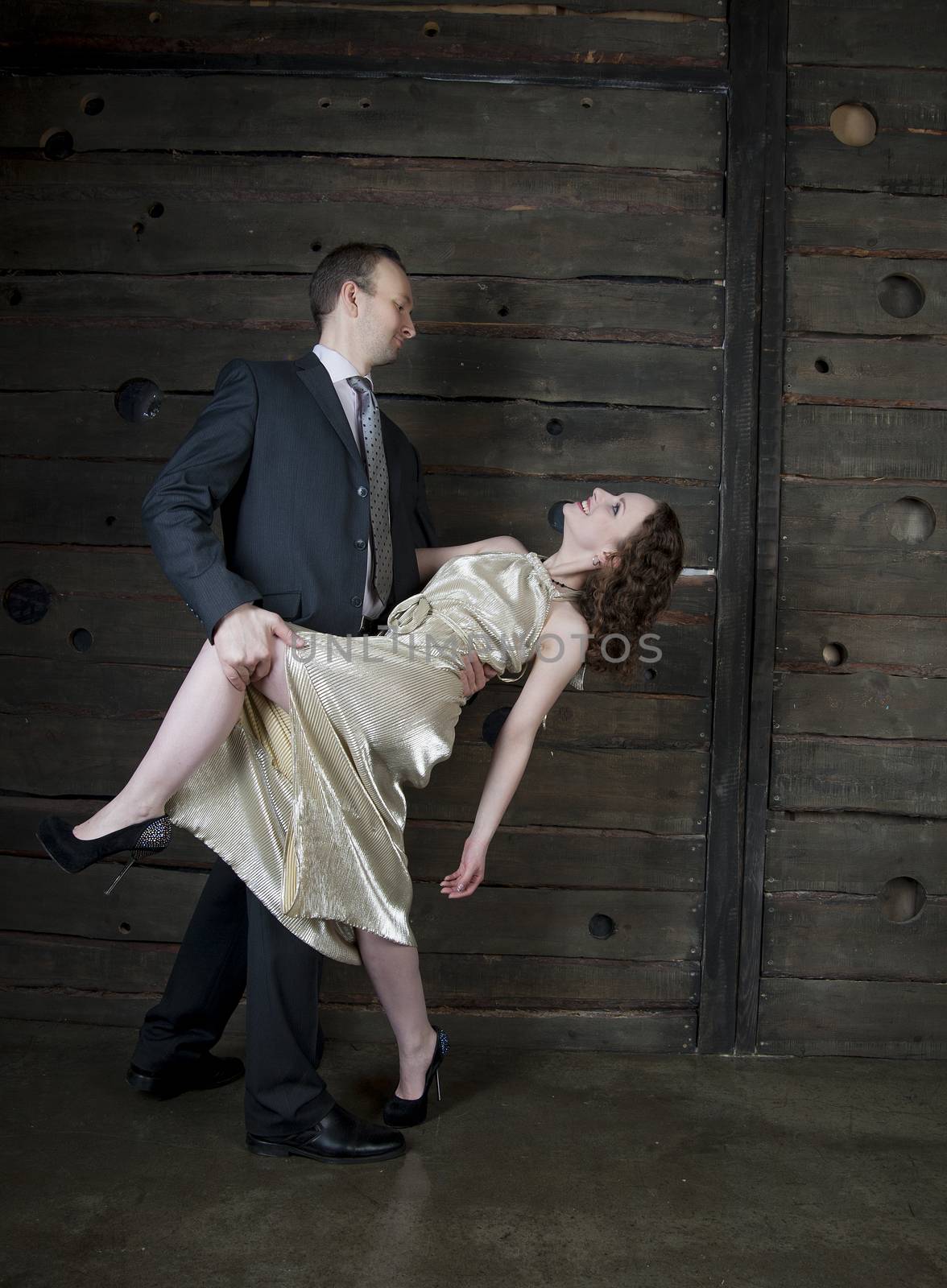 man and a woman dancing against the boards