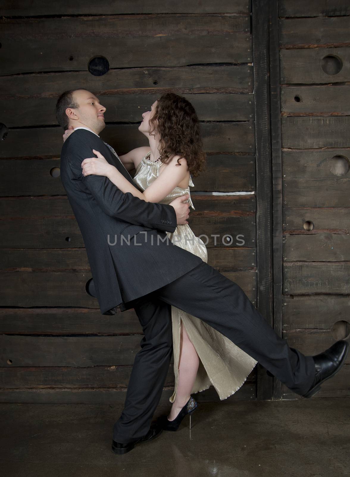 man and a woman dancing against the boards