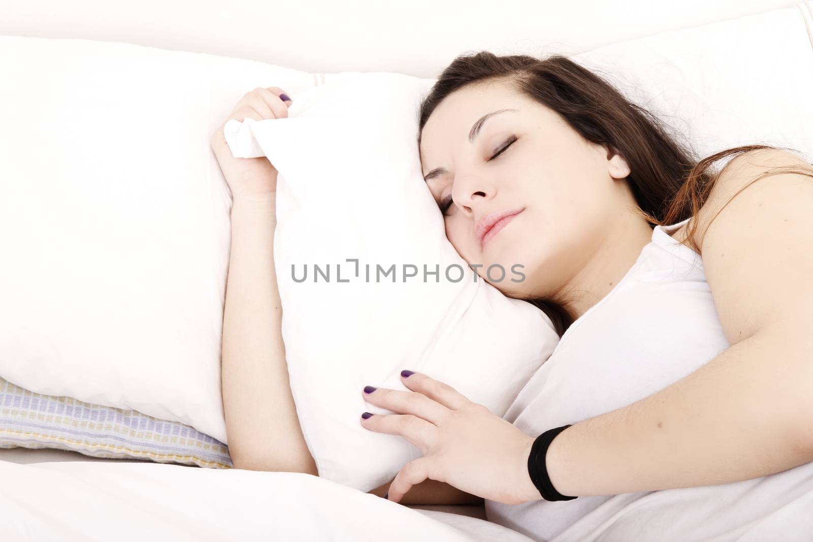 A young adult Woman sleeping on the Bed.