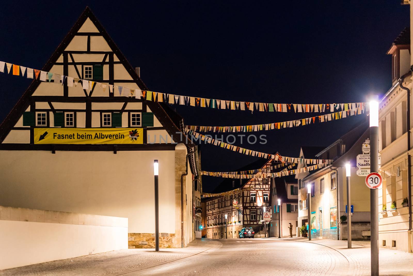 NEUHAUSEN, GERMANY ��� MARCH 4, 2014: The people of Neuhausen are about to celebrate the end of carnival (fasnet) season by burning a puppet that is wearing a traditional costume (called the ���H��s���) symbolizing carnival on March 4, 2014 in Neuhausen (near Stuttgart), Germany. Carnival has a very long tradition in Neuhausen with influences of the swabian alemanisch culture that can be seen by the wooden masks people are wearing as part of their costumes.