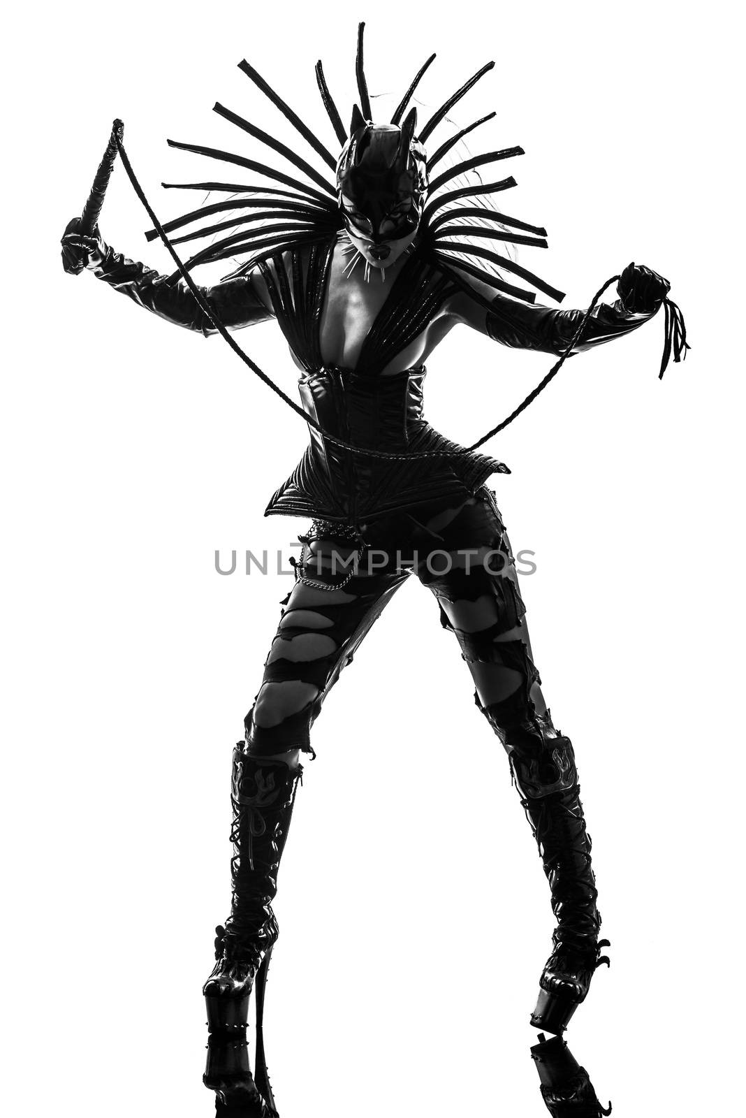 one caucasian woman in catwoman leather latex with whip in silhouette studio isolated on white background