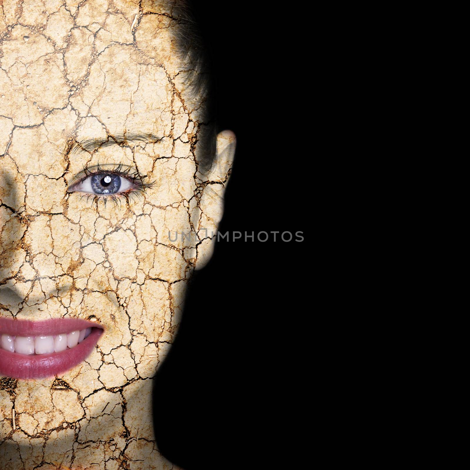 Beauty concept - woman face covered with cracked surface - symbol of dry skin