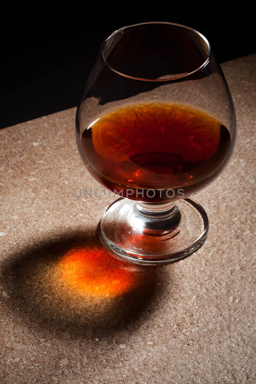 a glass of brandy on the marble table