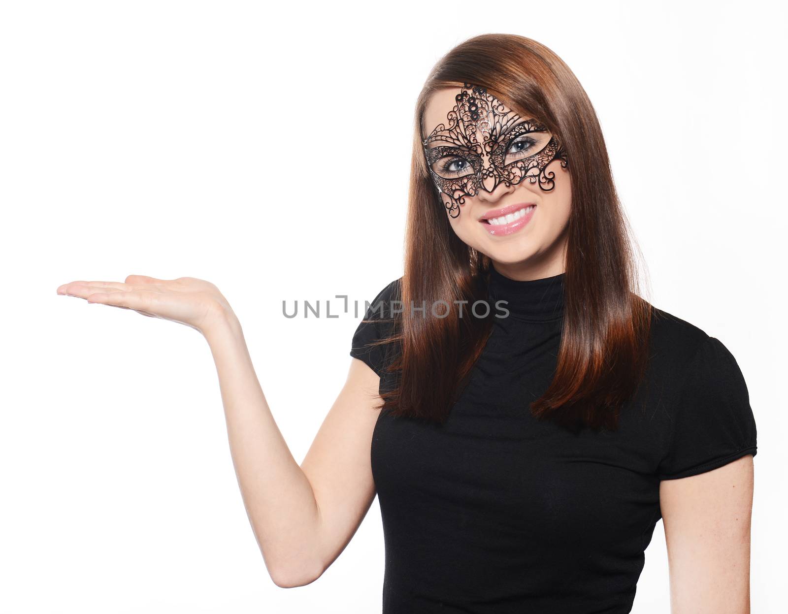 Beautiful woman in carnival mask pointing over white background