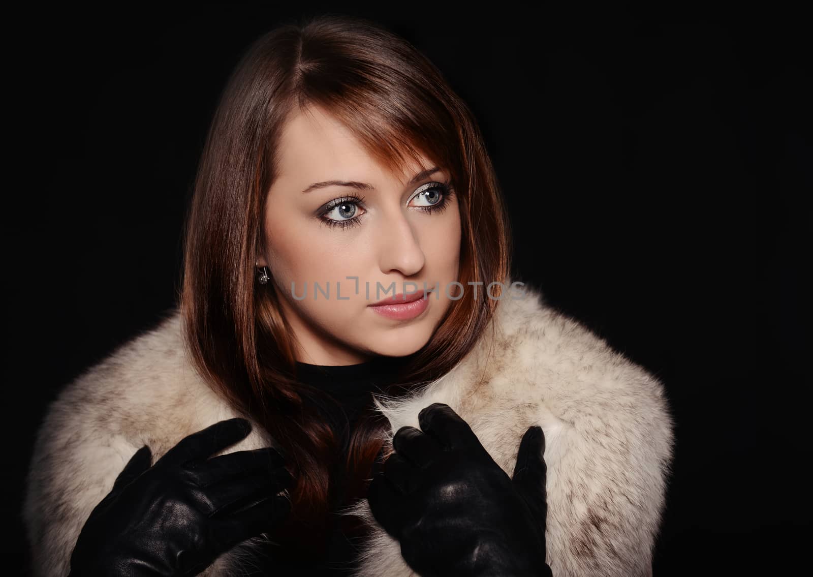 Beautiful caucasian brunette over black background