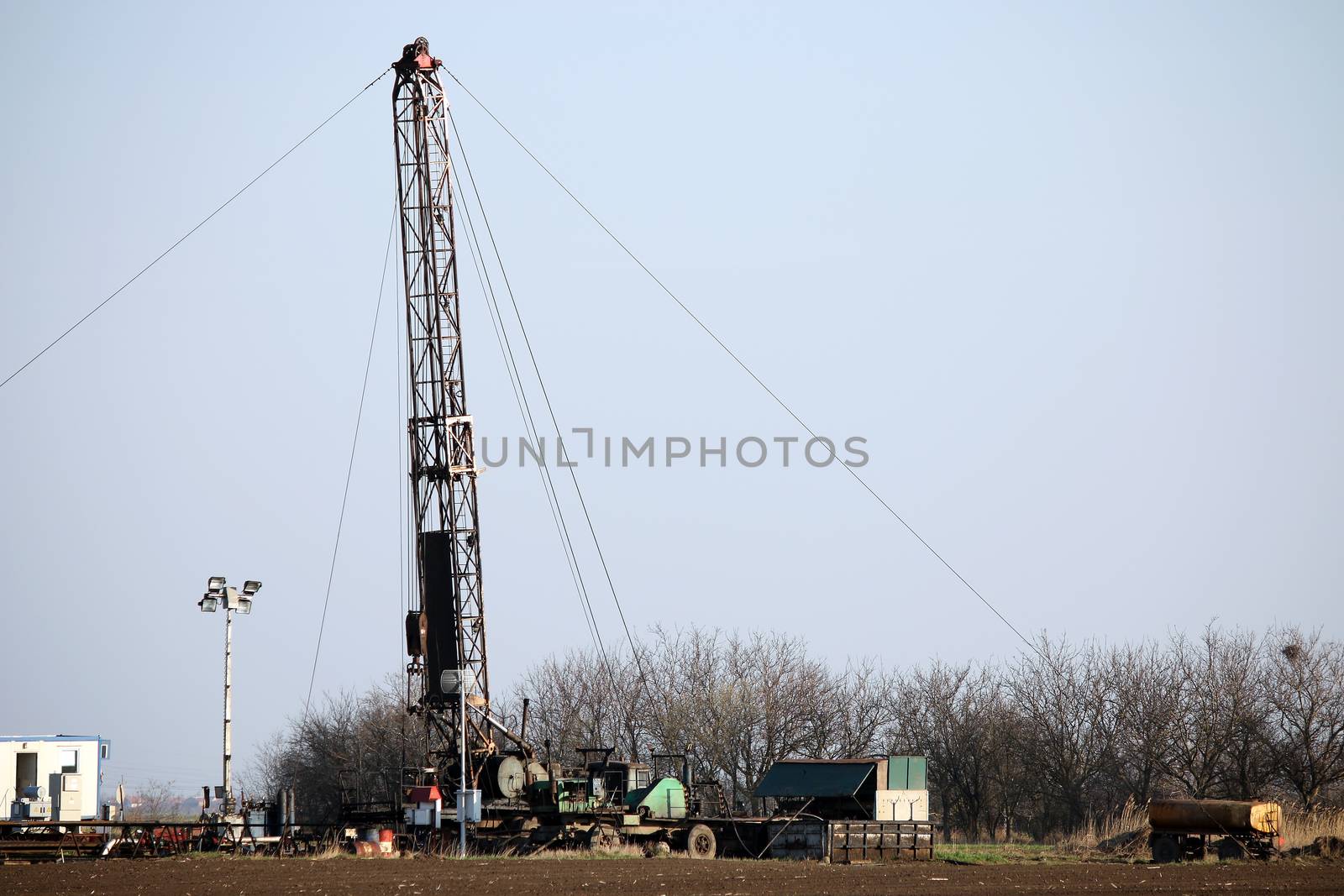 oil drilling rig and equipment on field by goce