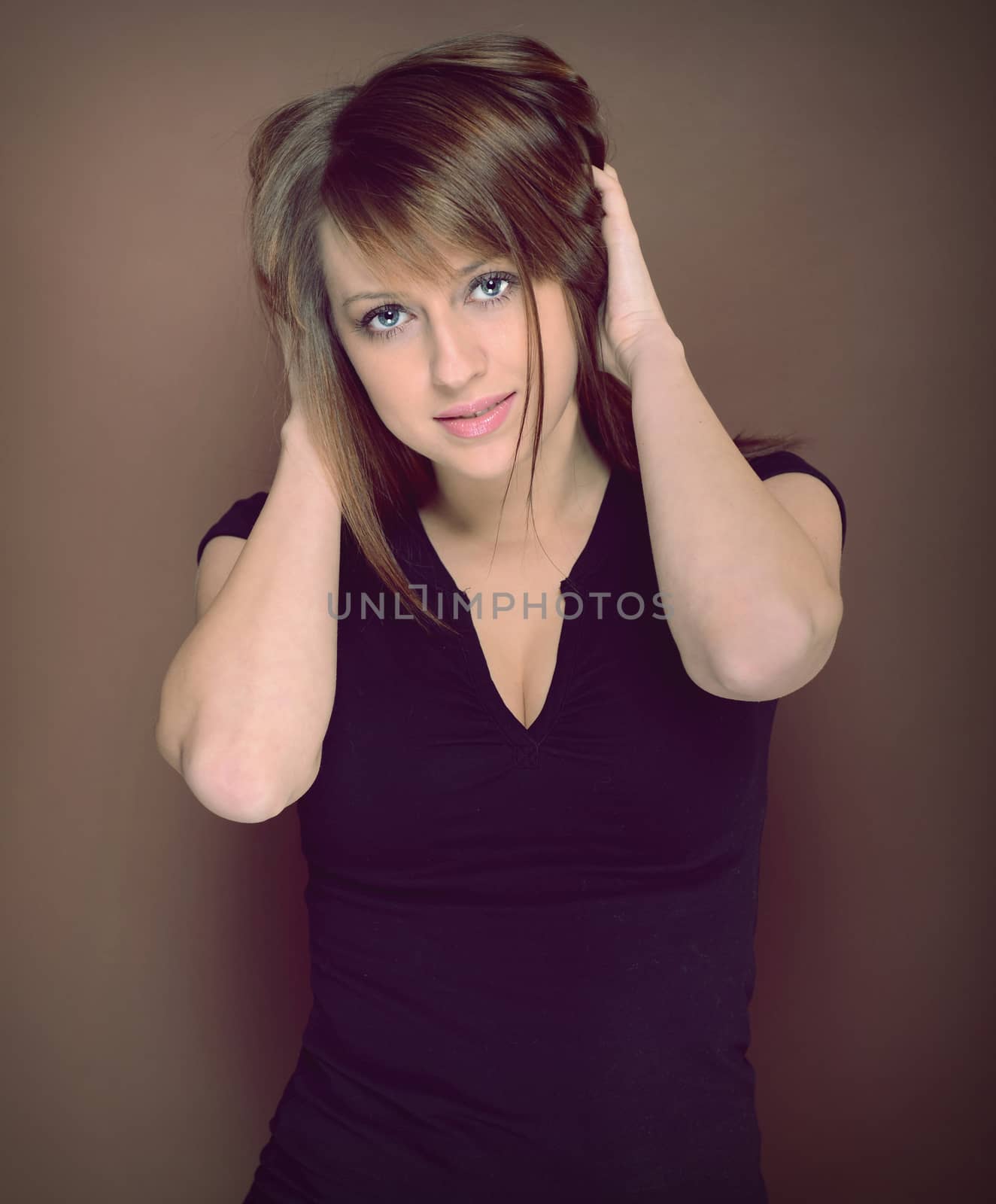 Beautiful brunette posing over brown background