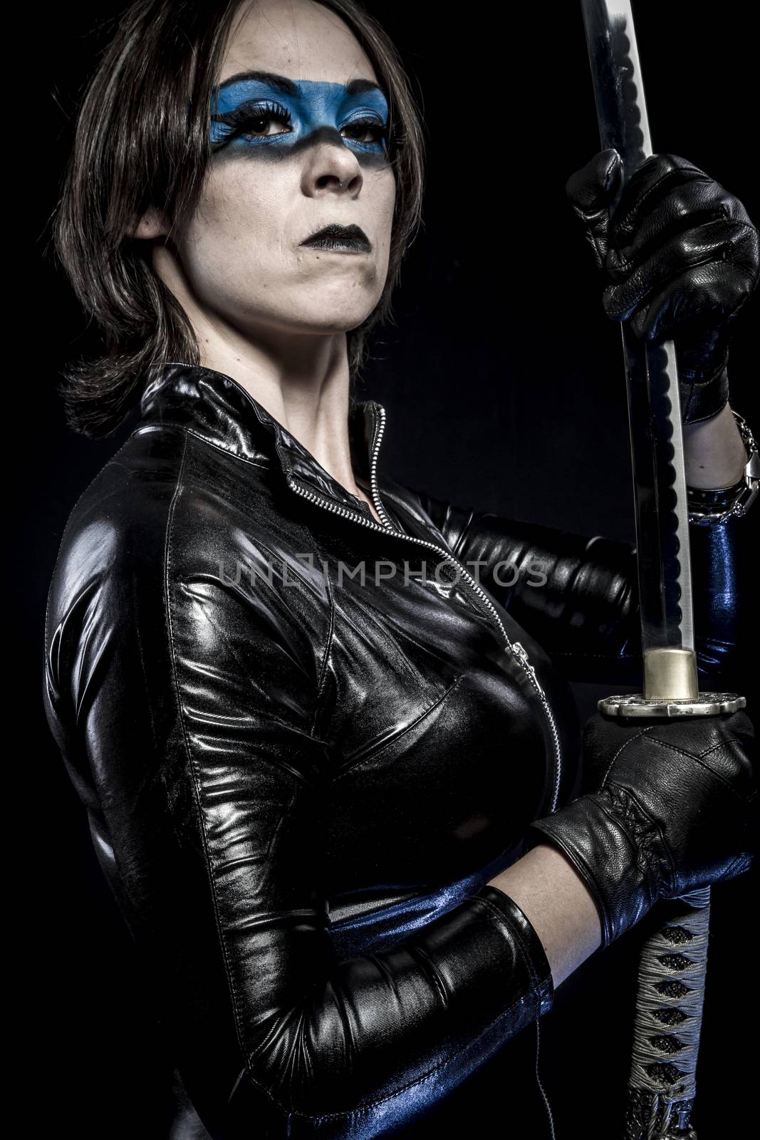 Woman with katana sword in latex costume