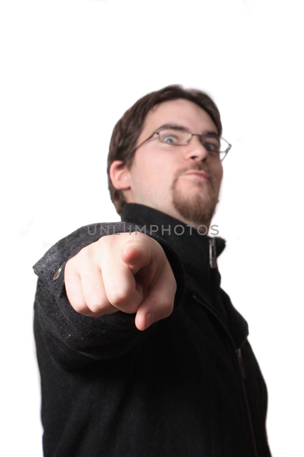 Young man wearing coat and glasses points his finger at you on a white background