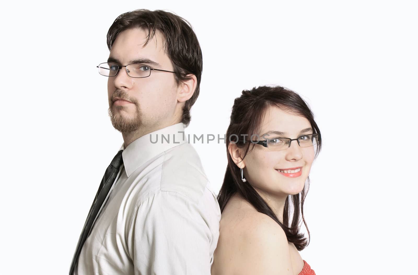 Cute young couple happy together standing back to back on a white background