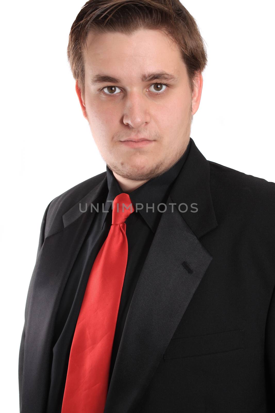 Handsome young businessman in black formal suit with red tie