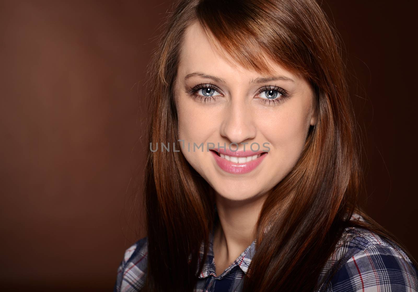 Beautiful brunette posing over brown background