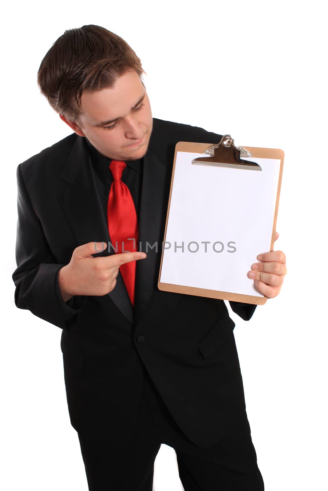 Businessman pointing at and holding a clipboard with a blank page on a white background