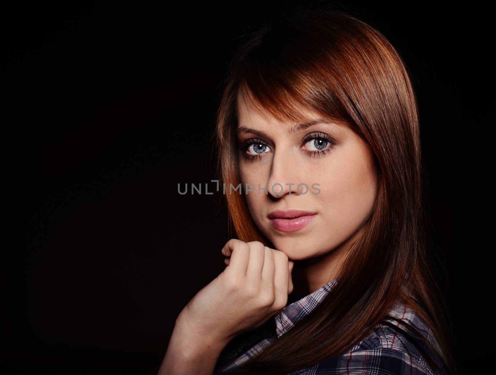 Beautiful brunette posing over dark background