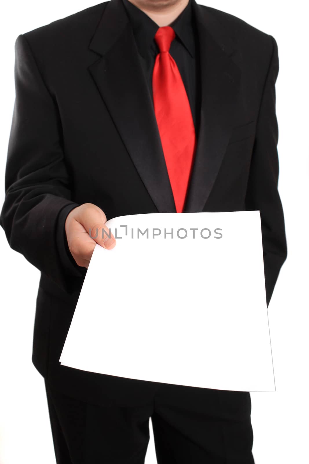 Businessman in formal black suit gives blank document on a white background