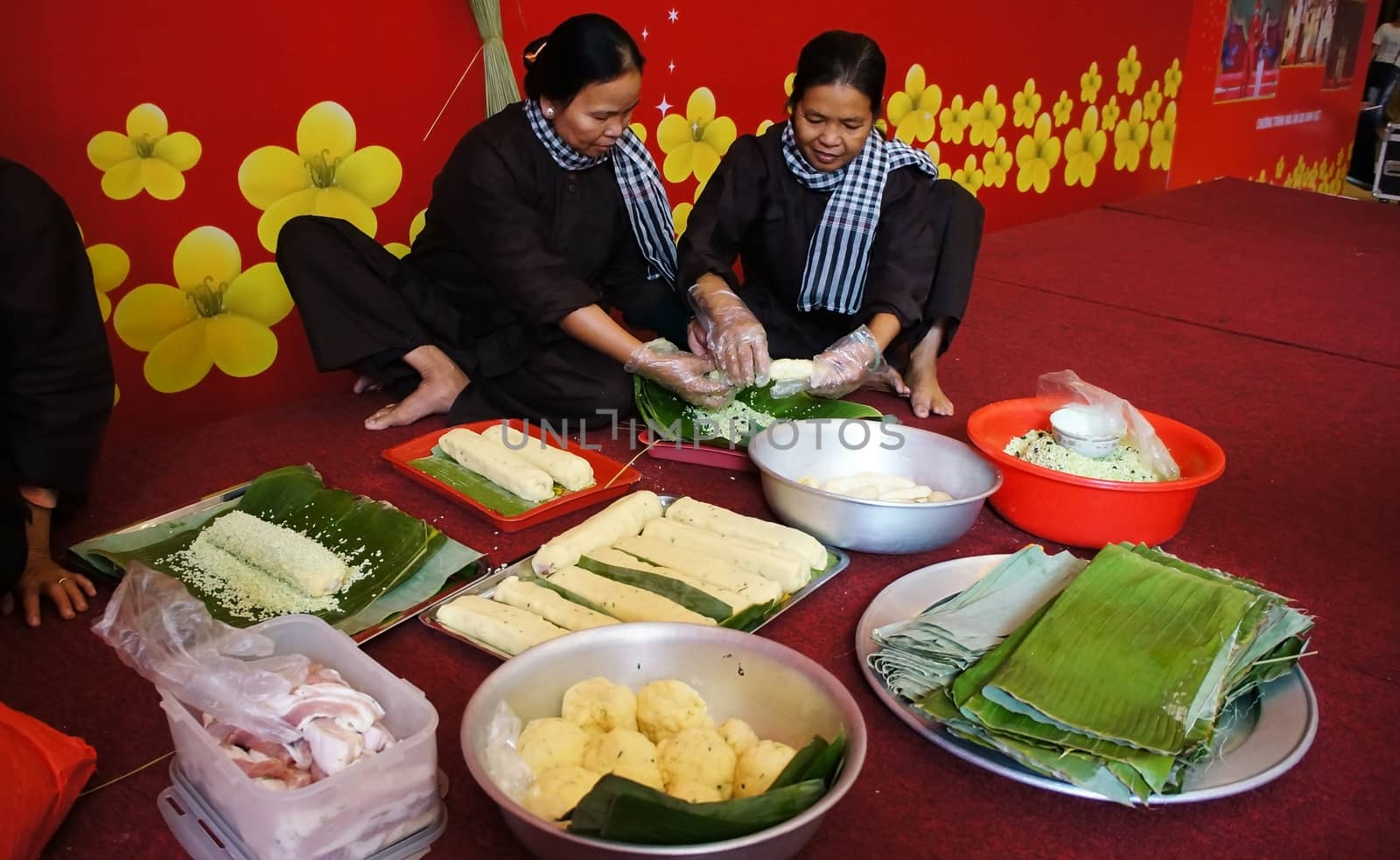 VIET NAM- JAN 15: People with traditional Vietnamese dress making traditional food- cylindric rice cake ( banh Tet) for Tet ( Lunar New Year), this 's beautiful culture in Vietnam, Jan 15, 2013