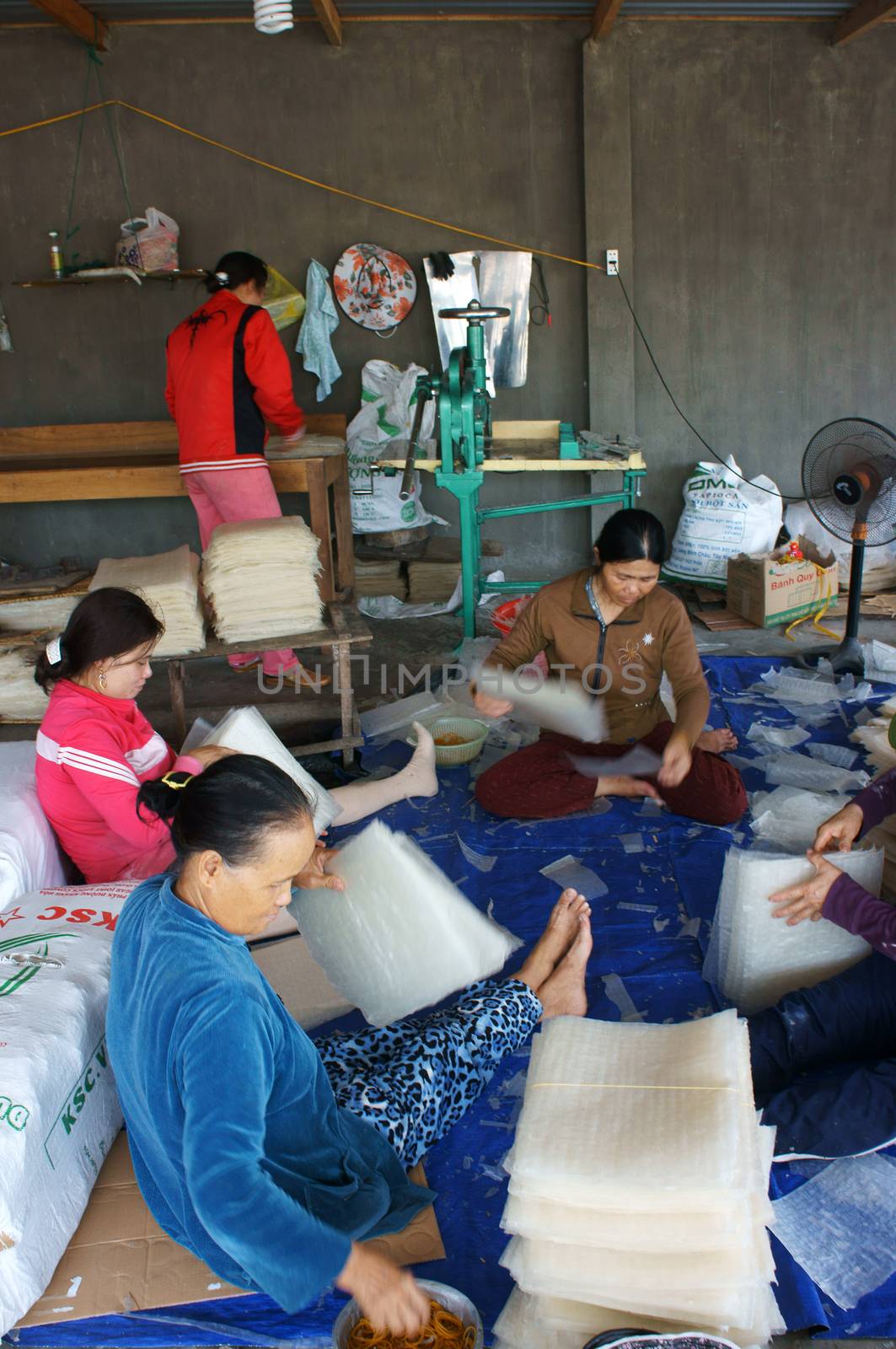 BINH THUAN, VIET NAM- FEBRUARY 4: People working in group at girdle cake  workshop in Binh Thuan, VietNam on February 4, 2013