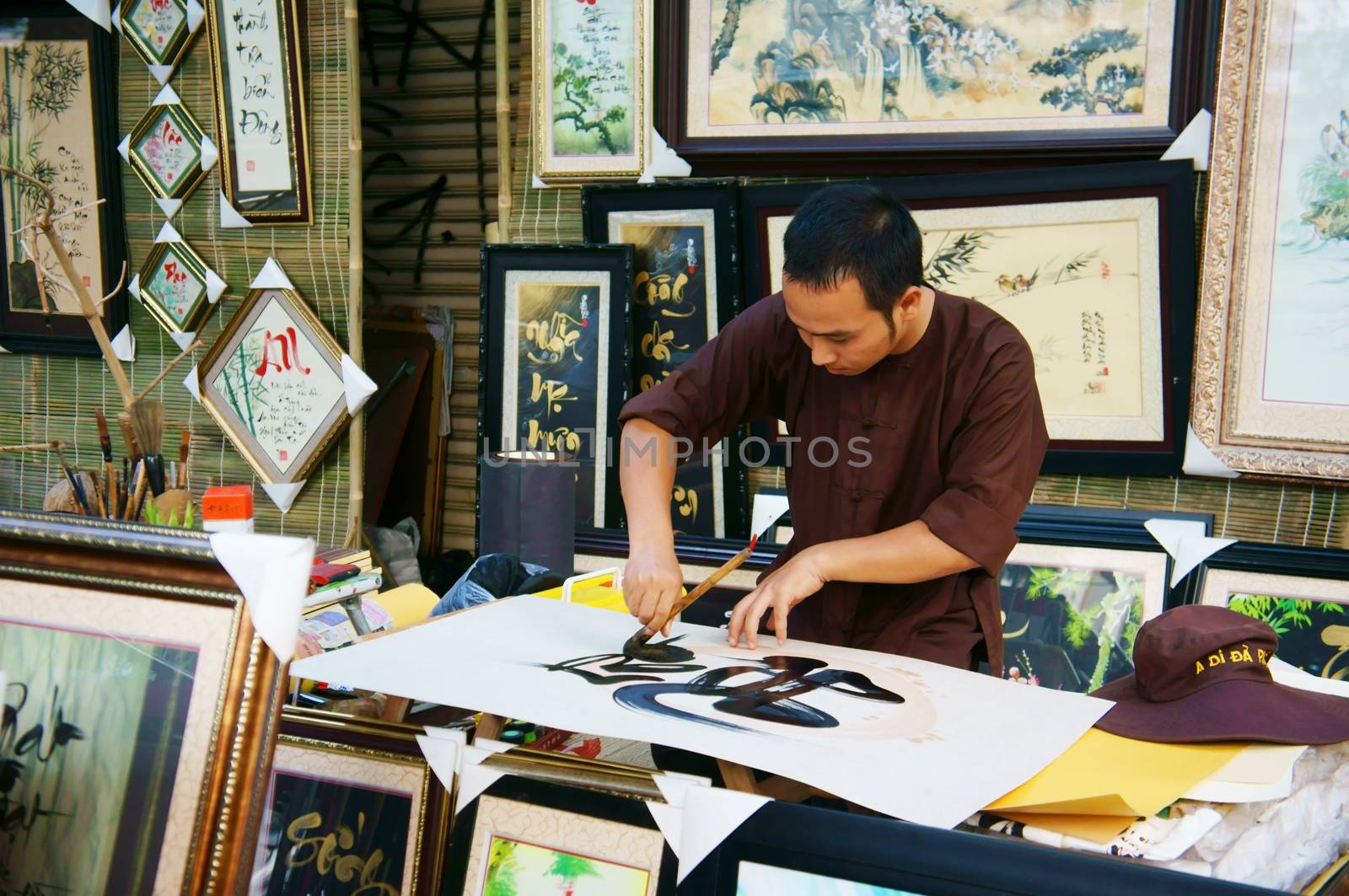 SAI GON, VIET NAM- FEBRUARY 1, 2013. People writing calligraphy at fair, this is traditional culture of Vietnamese in springtime, Sai gon, VietNam on February 1, 2013