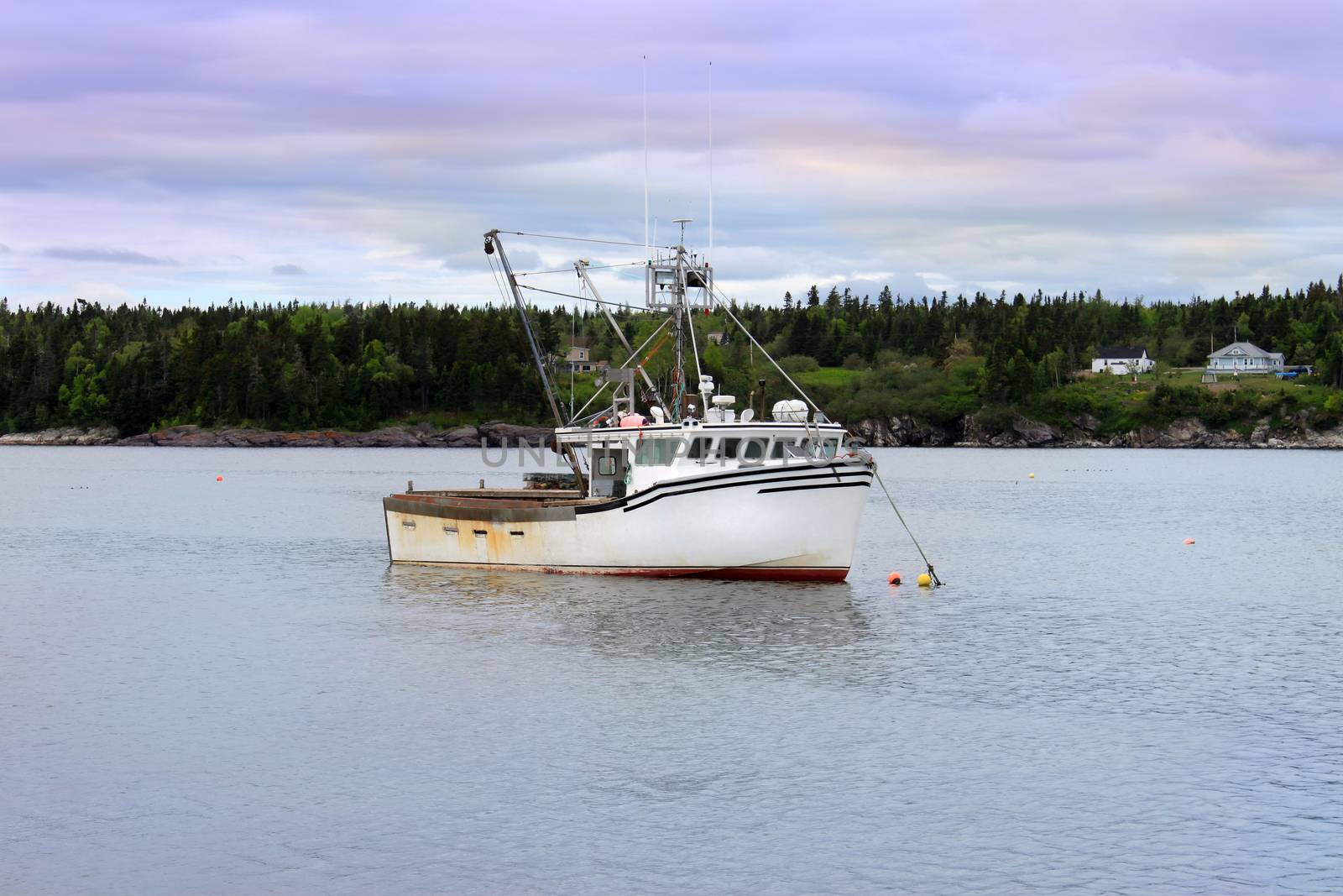 Fishing boat under dramatic tinted sky in the waters of the Bay of Fundy, in New Brunswick, Canada