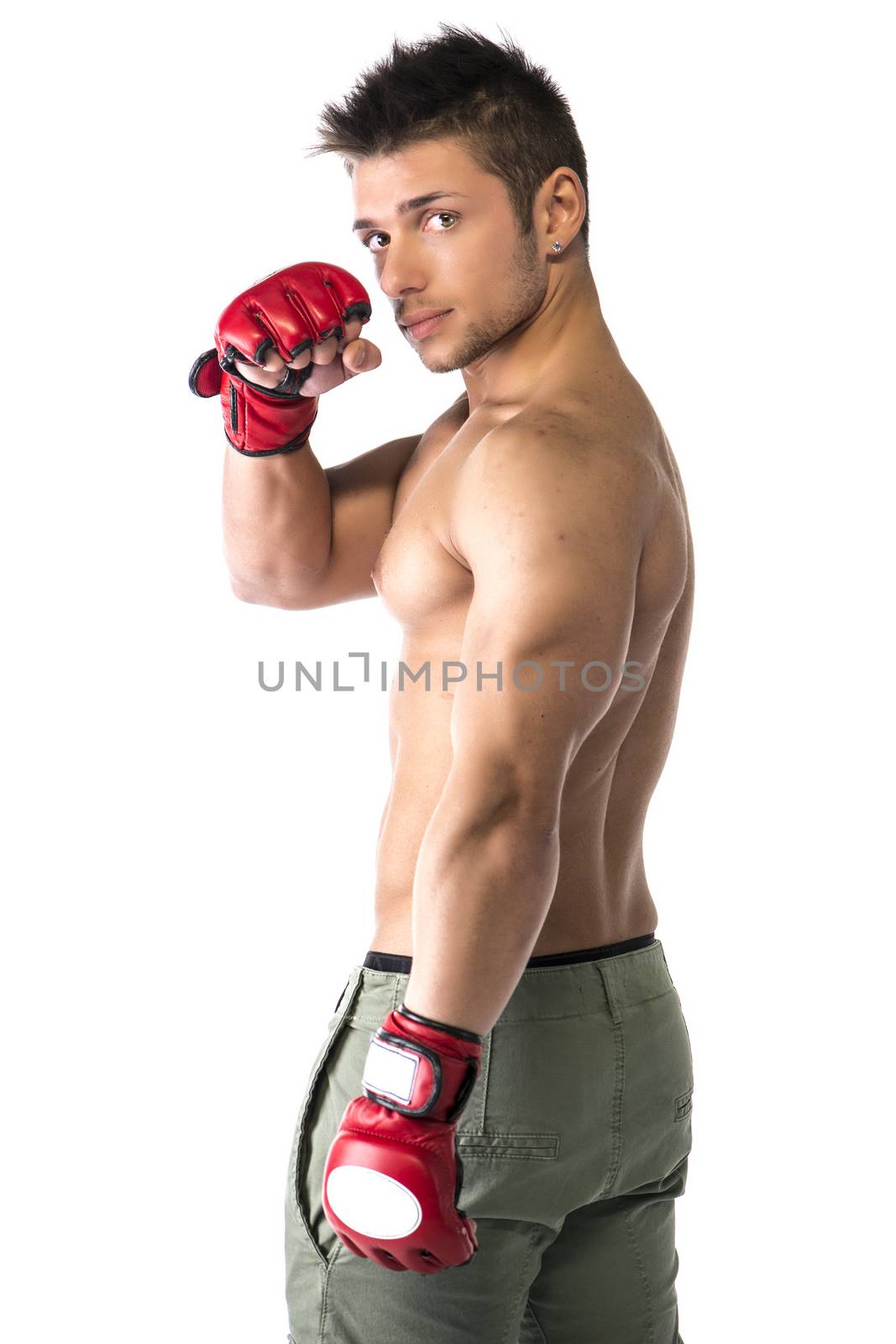 Muscular shirtless young man with mixed martial arts gloves (MMA), profile view, isolated