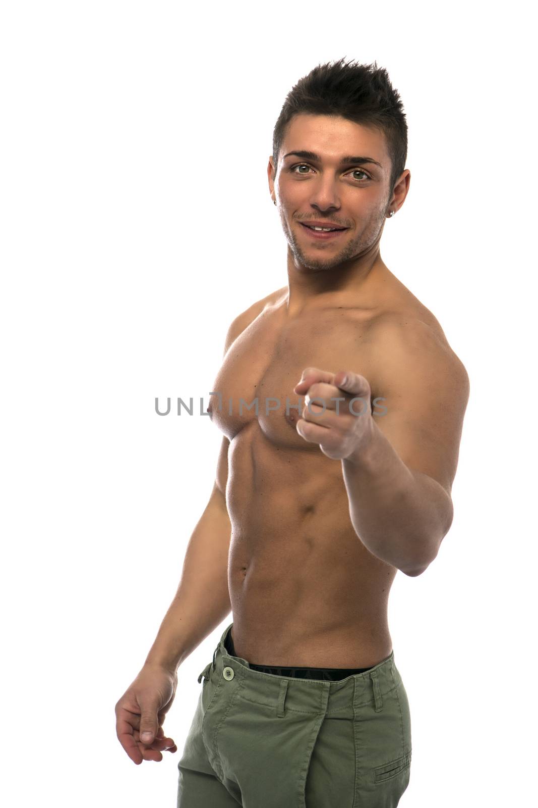 Confident, smiling young man shirtless with muscular torso, ripped abs and pecs, pointing finger to camera