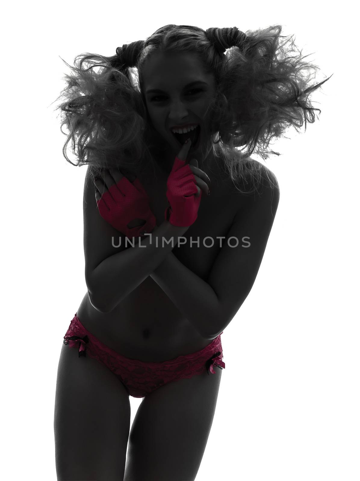 one caucasian sexy woman laughing topless with pink underwear in silhouette studio isolated on white background