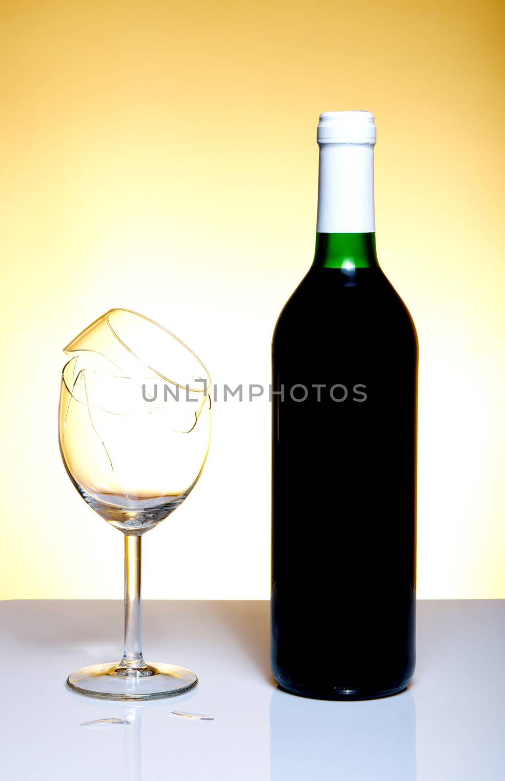 Vine bottle and broken glass on orange background by anderm