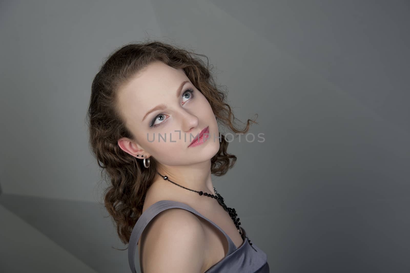 woman in a grey dress with a grey background