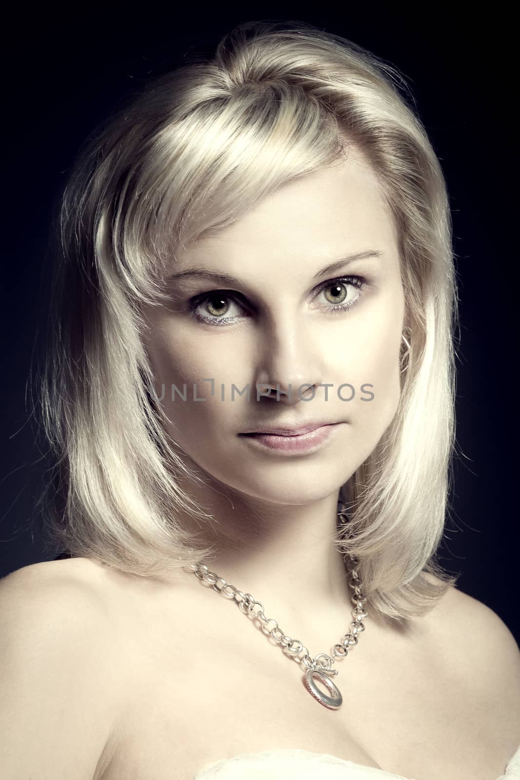 studio portrait of beautiful woman with white dress on black background