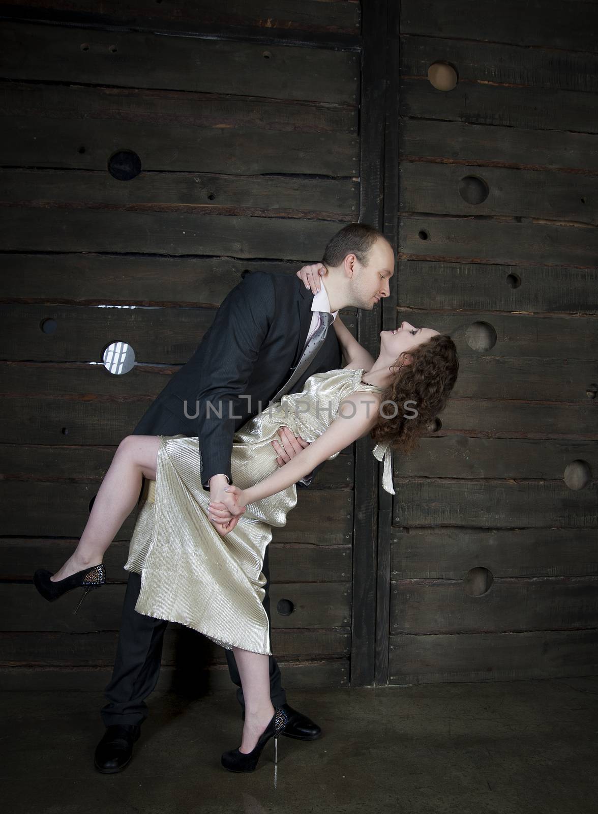 man and a woman dancing against the boards