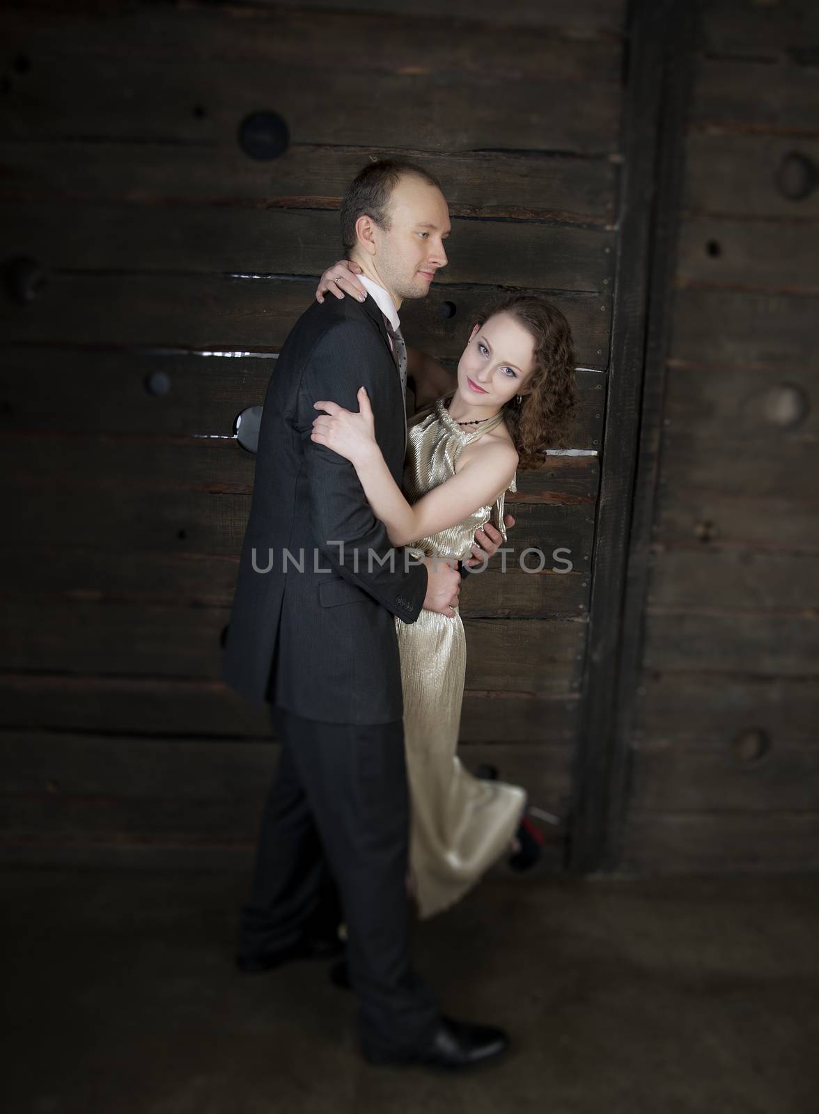 man and a woman dancing against the boards