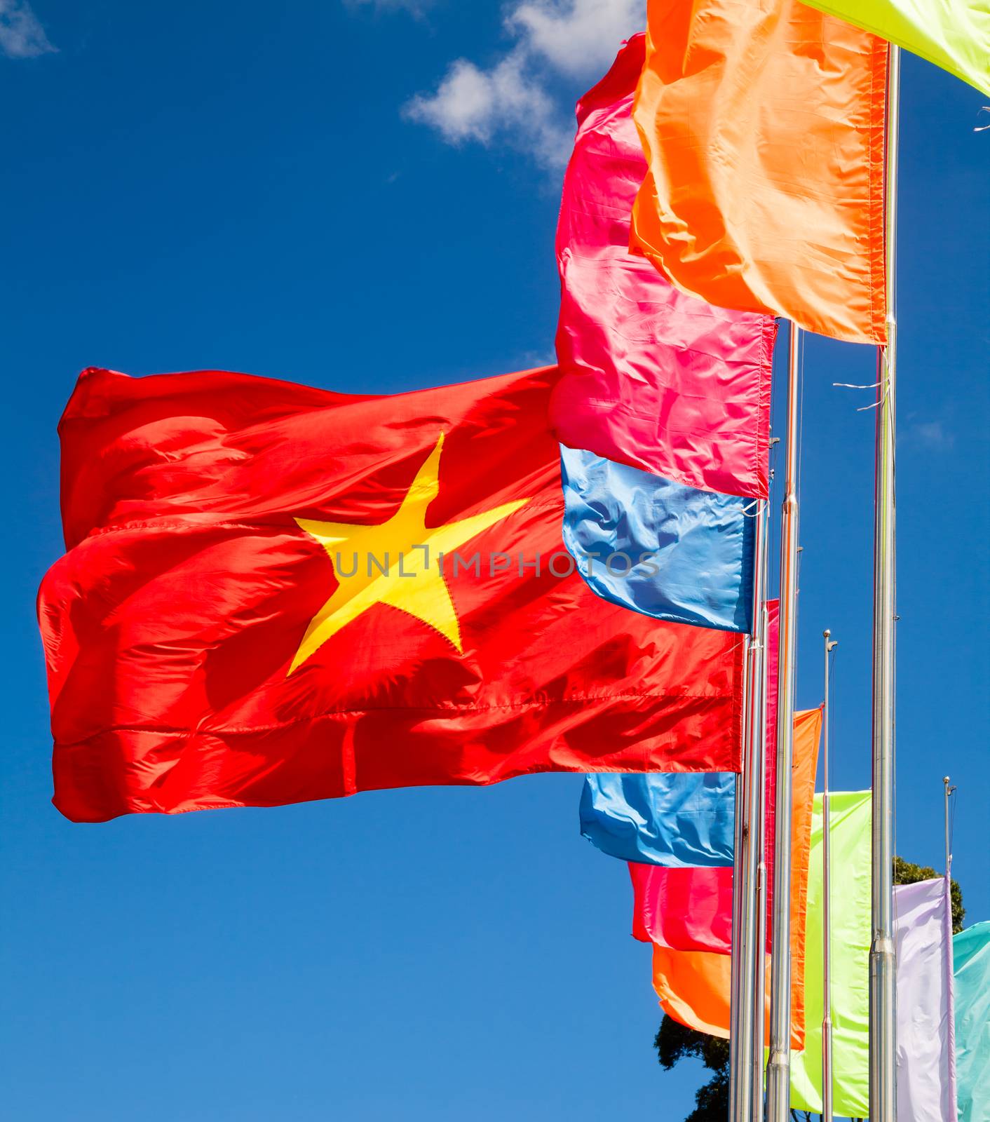 Vietnamese flag waving in the wind against blue sky