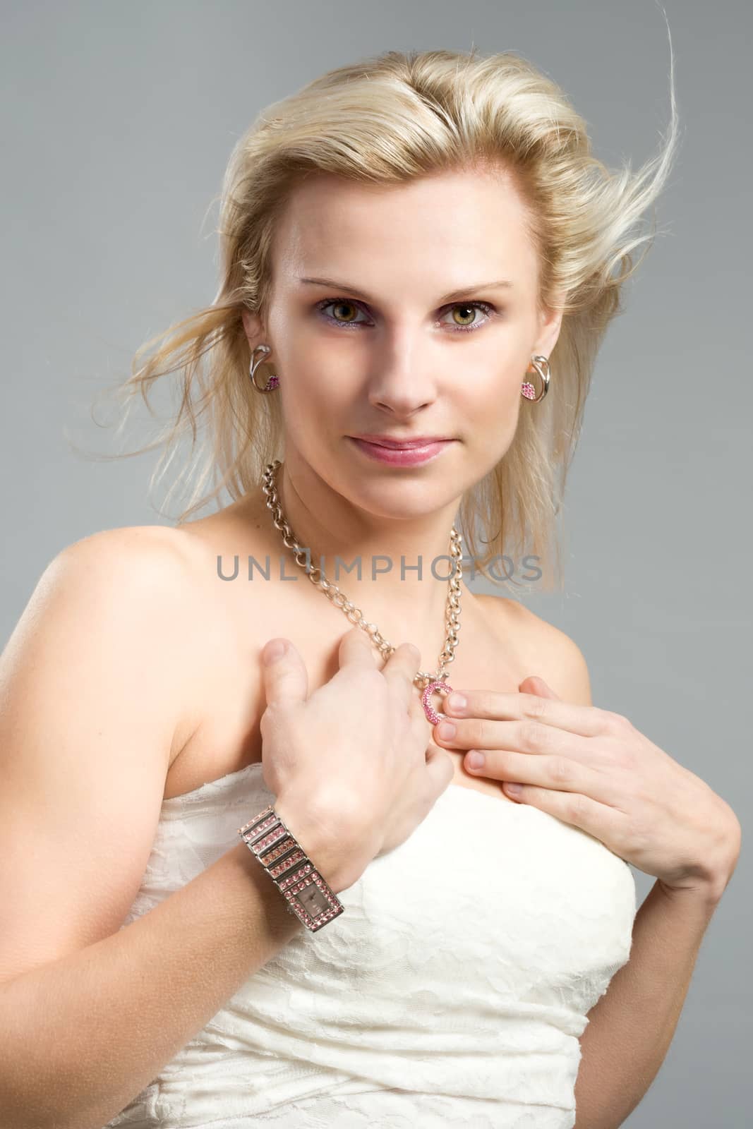 studio portrait of beautiful woman with white dress and waving hair