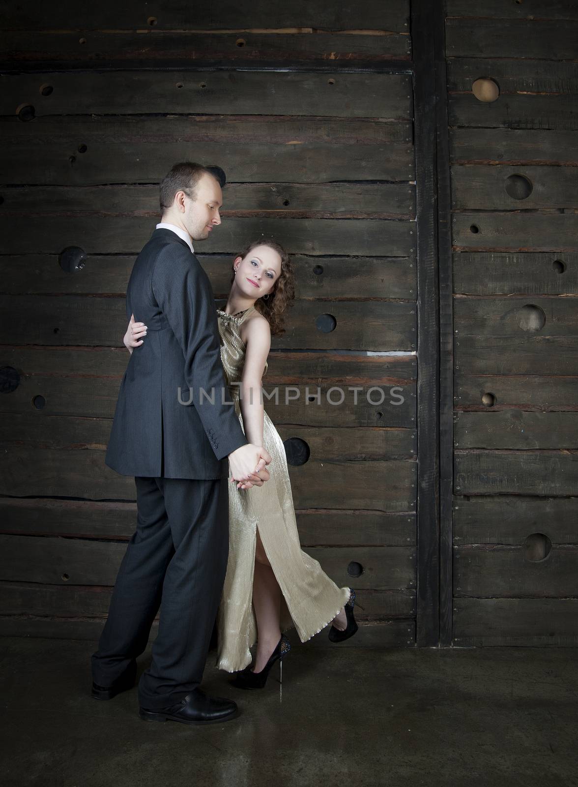 man and a woman dancing against the boards