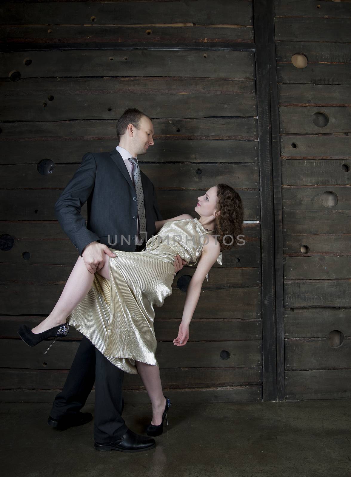 man and a woman dancing against the boards