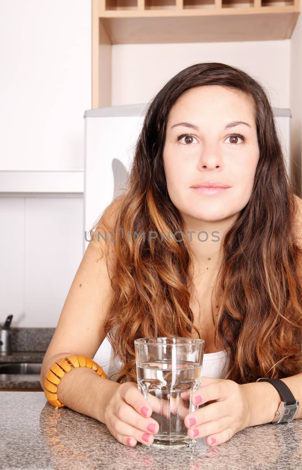 A young woman with a glass of water.